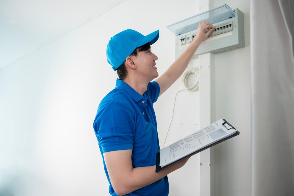 Technician service man checking electrical appliances