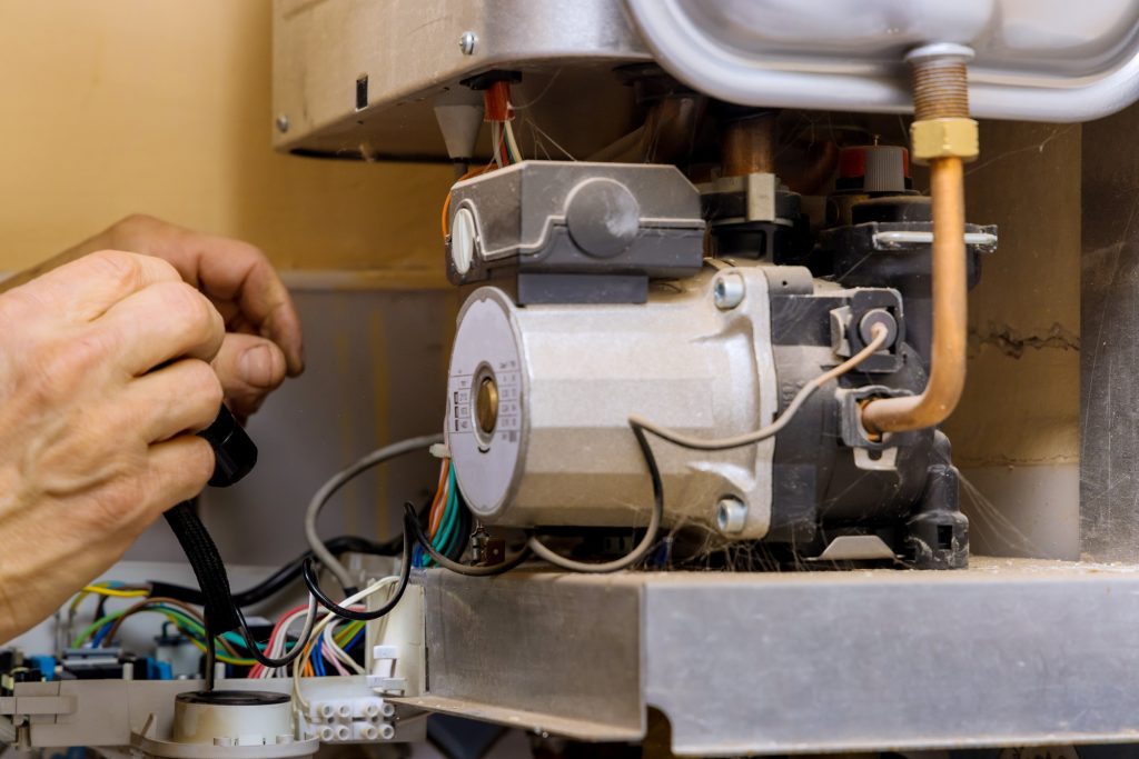 Tehnic fix the problem servicing on gas boiler for hot water and heating