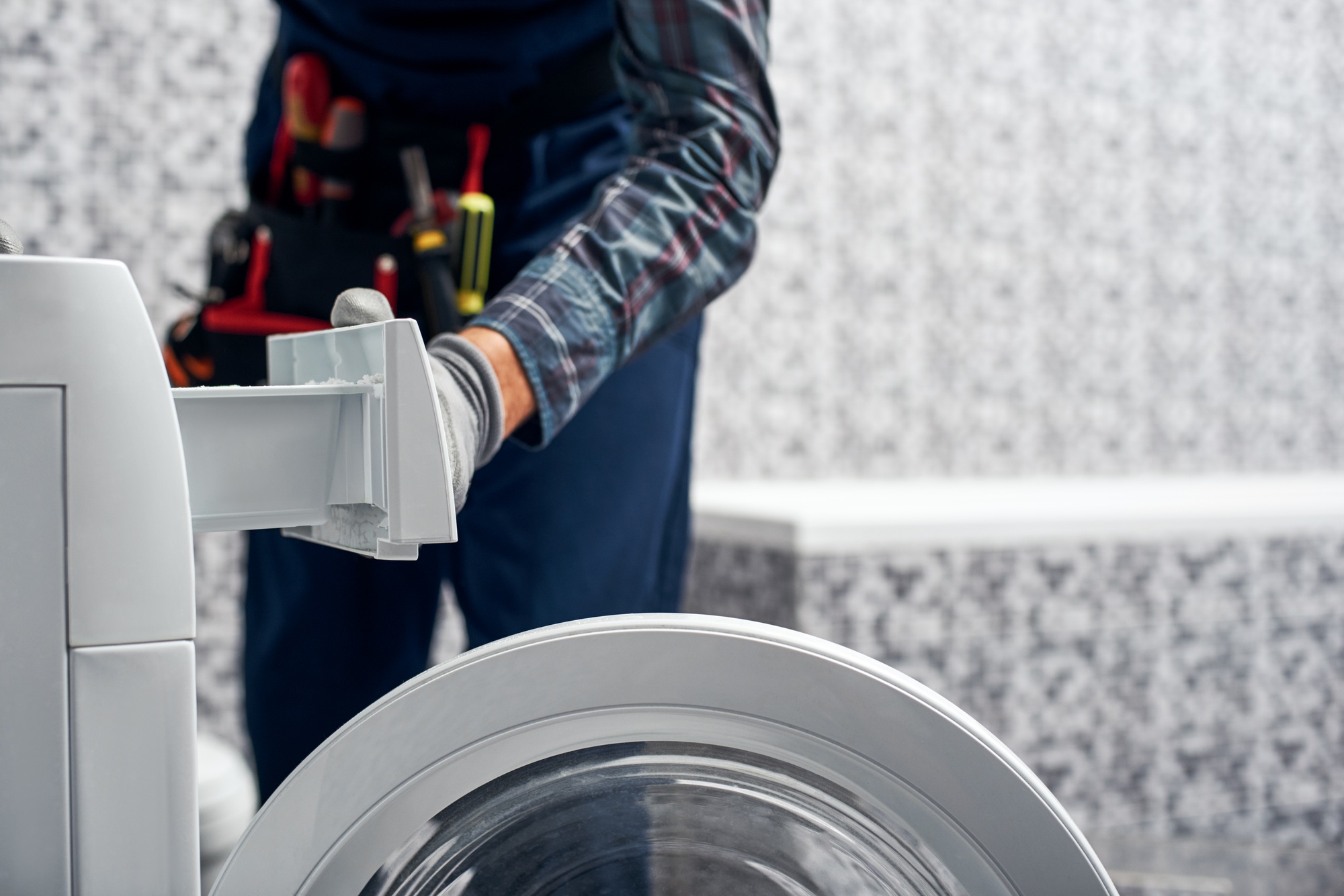 Detailed inspection. Working man plumber in bathroom checking