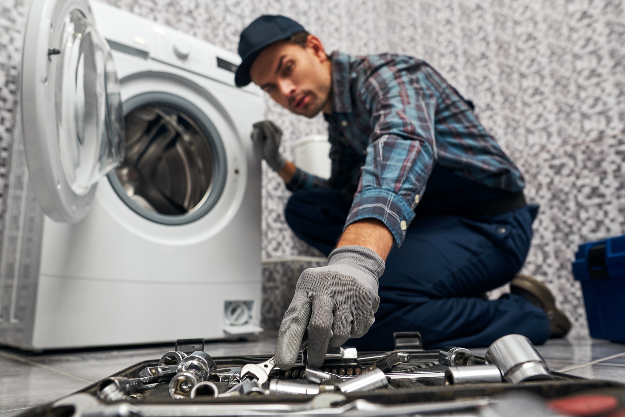Necessary things are always at hand. Working man plumber in bathroom blurred