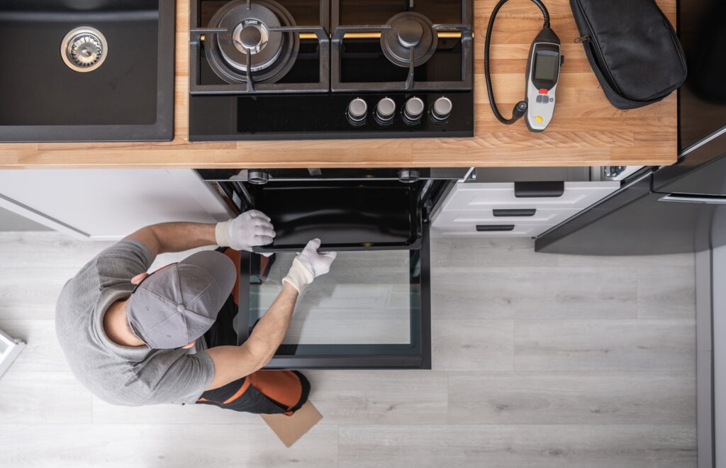 Professional Appliances Installer and Testing New Kitchen Stove