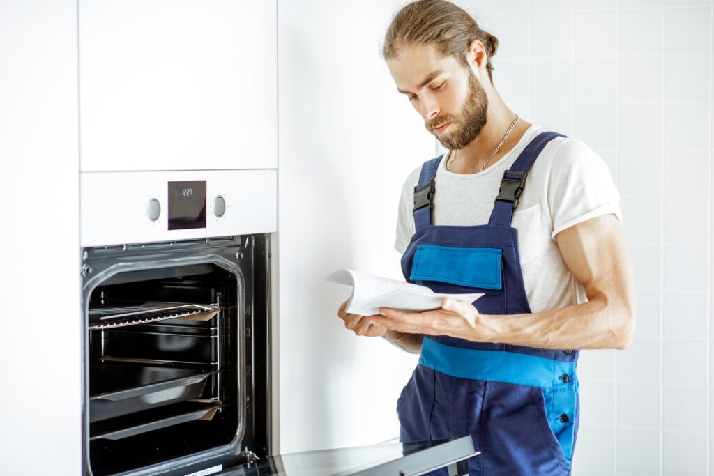 Workman setting up electric oven