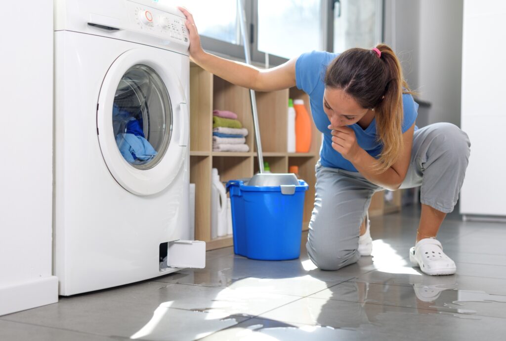 Woman checking a water leak on the floor